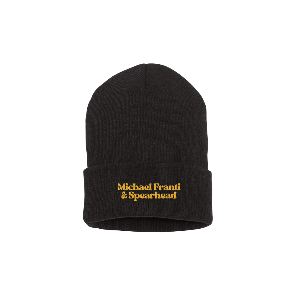 Black knit beanie with ’Michael Franti & Spearhead’ embroidered in yellow text.