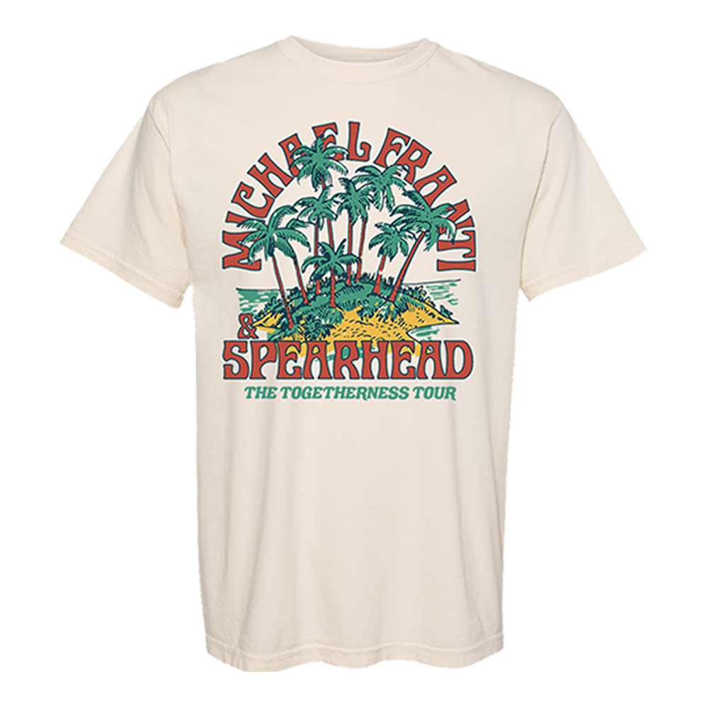 Cream-colored t-shirt with a colorful tropical design featuring palm trees and text reading ’Michael Franti Spearhead The Togetherness Tour’.