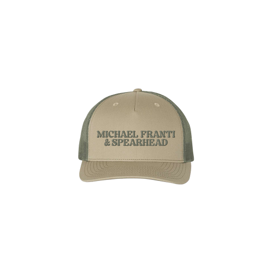 Tan and olive green trucker-style baseball cap with ’MICHAEL FRANTI & SPEARHEAD’ text.
