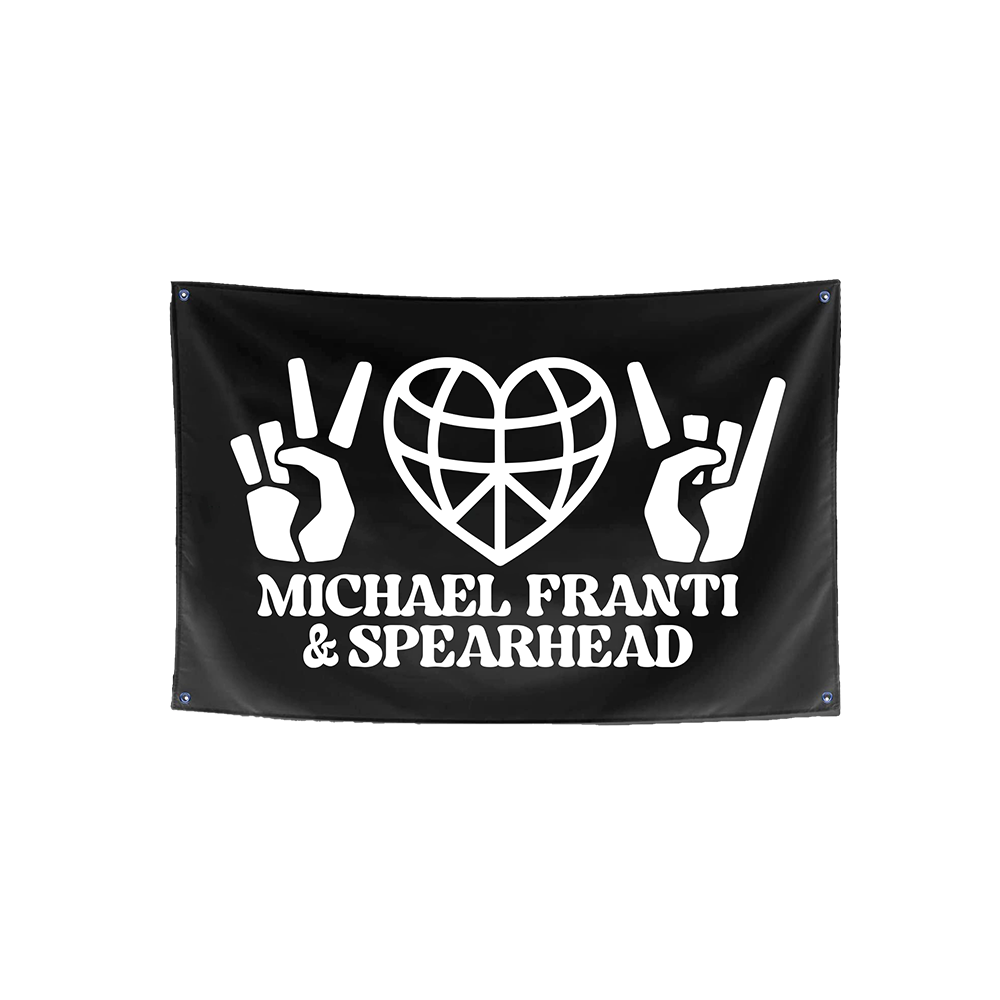 Black flag with white graphics and text for Michael Franti & Spearhead.