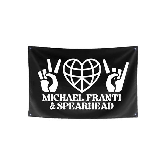 Black flag with white graphics and text for Michael Franti & Spearhead.