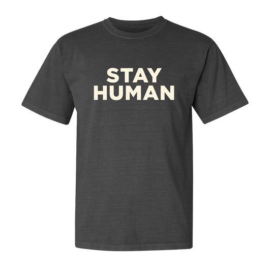 Dark gray t-shirt with ’STAY HUMAN’ printed in large white letters on the front.