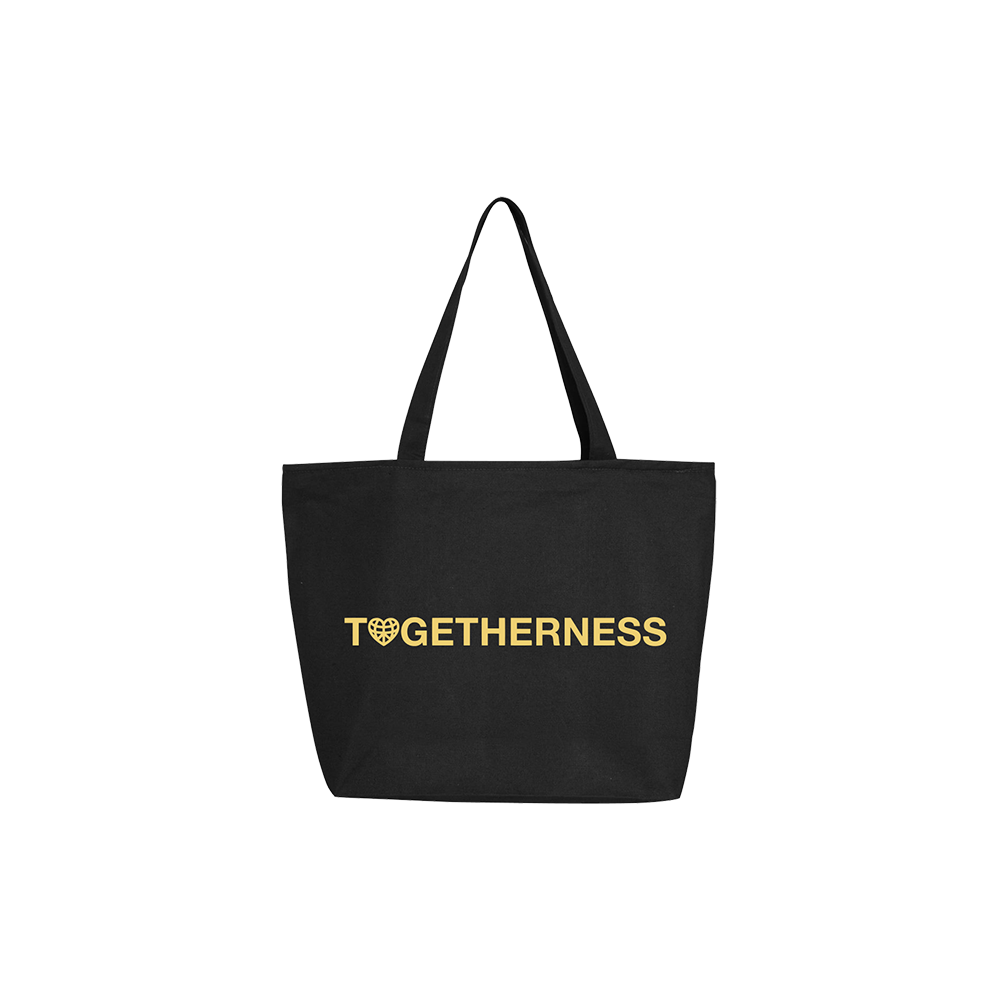 Black tote bag with ’TOGETHERNESS’ printed in gold lettering, featuring a heart symbol in place of the letter ’O’.