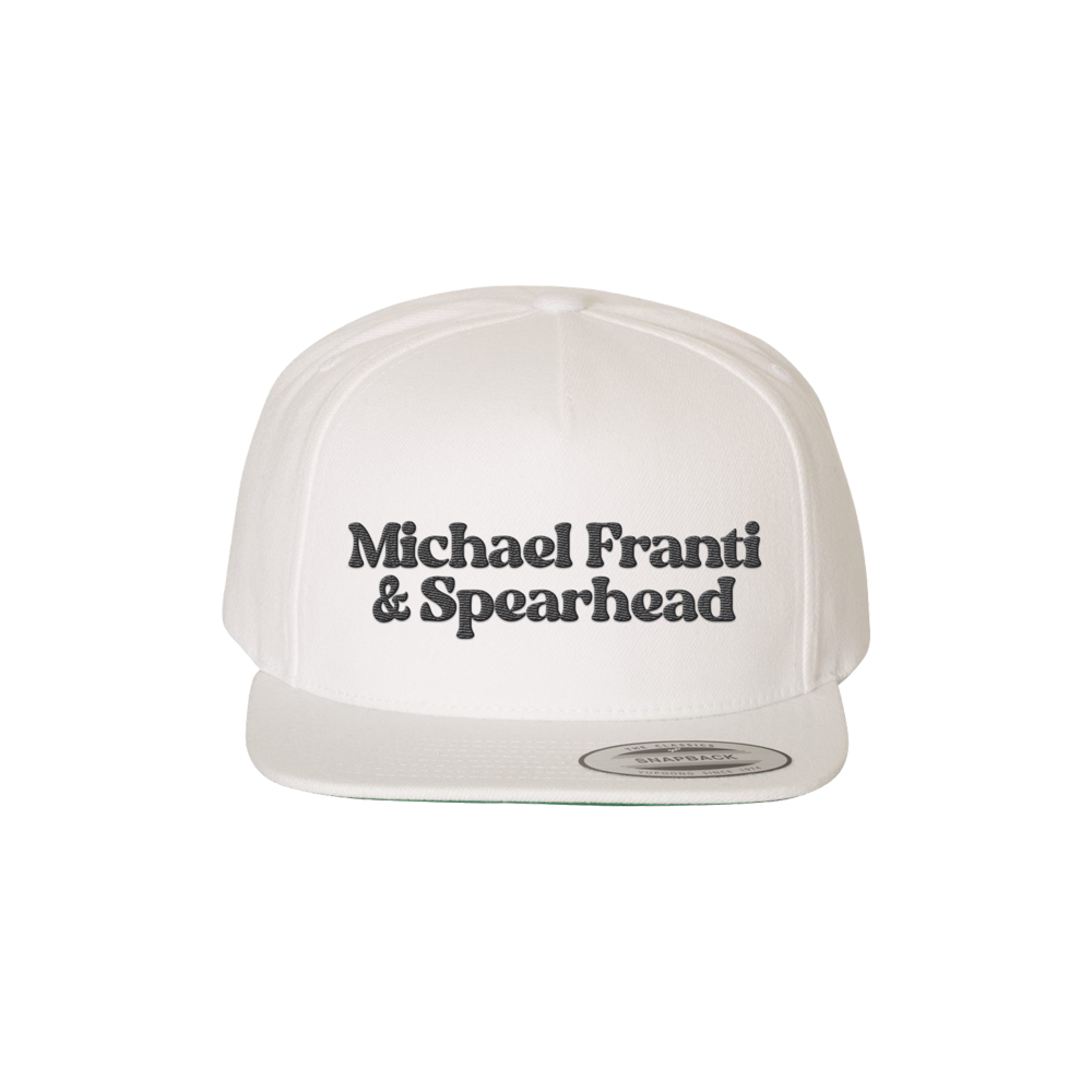White baseball cap with ’Michael Franti & Spearhead’ printed on the front.