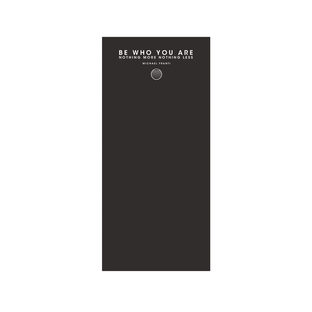 Dark gray or black notebook with an inspirational quote on the cover.