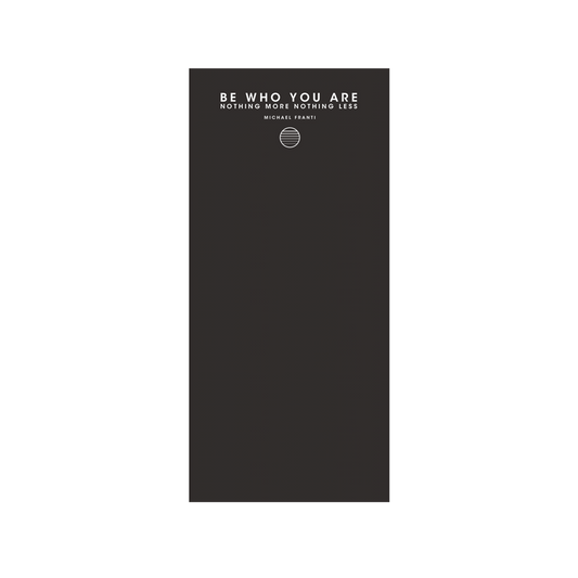 Dark gray or black notebook with an inspirational quote on the cover.