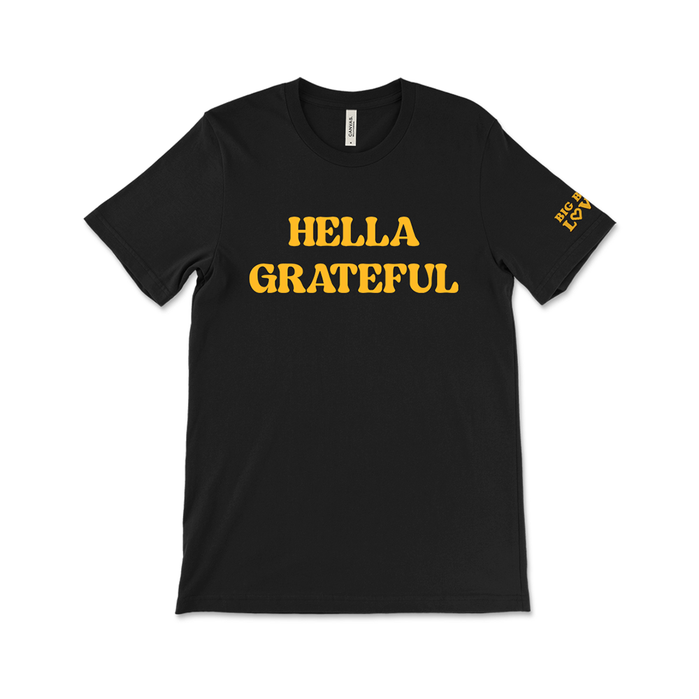 Black t-shirt with yellow text reading ’HELLA GRATEFUL’ on the front.
