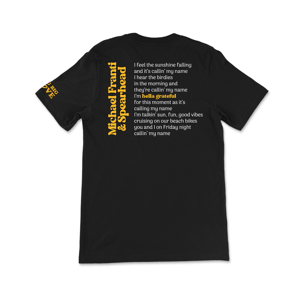 Black t-shirt with yellow text printed on the back.