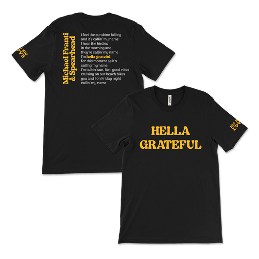 Black t-shirt with yellow text featuring lyrics and the phrase ’HELLA GRATEFUL’ on the front.