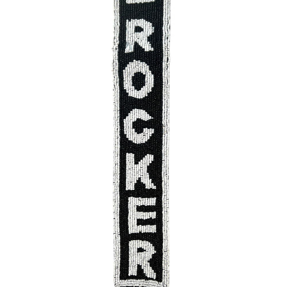 Vertical black and white woven band with the word ’ROCKER’ spelled out vertically.