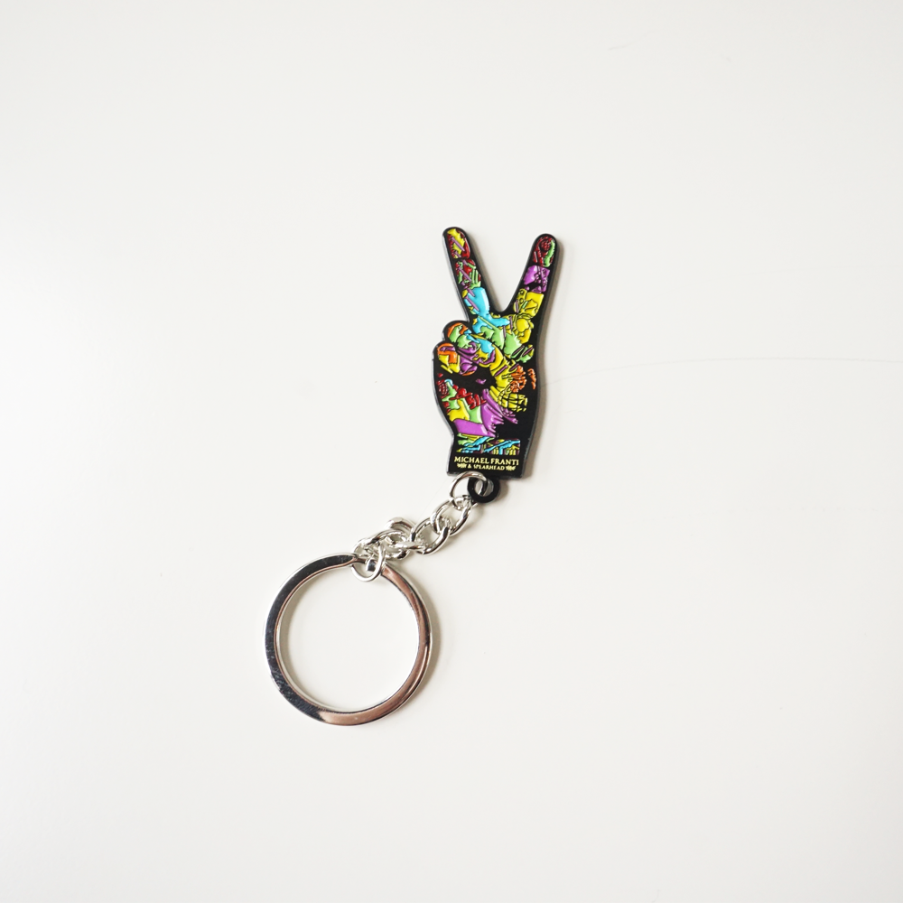 Colorful peace sign keychain with a vibrant, psychedelic design.