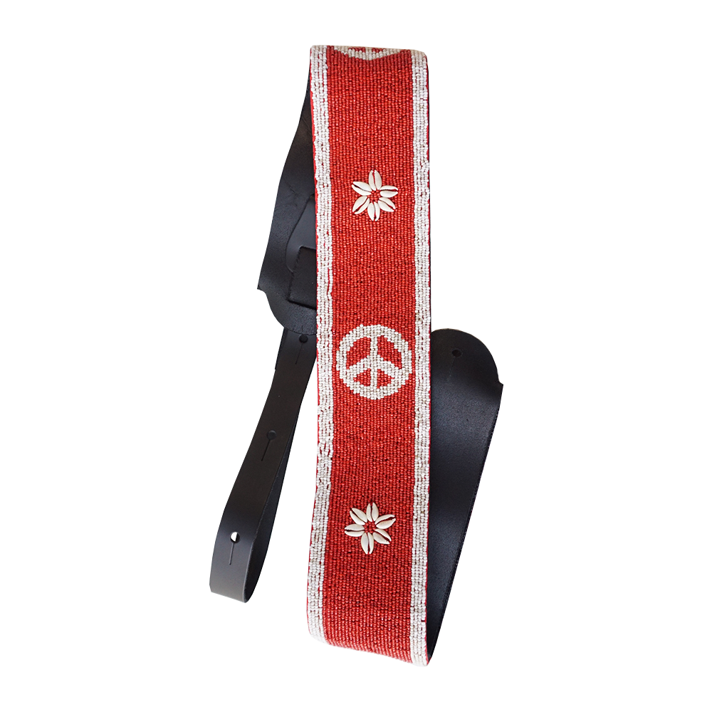 Red guitar strap with white peace symbol and flower designs.