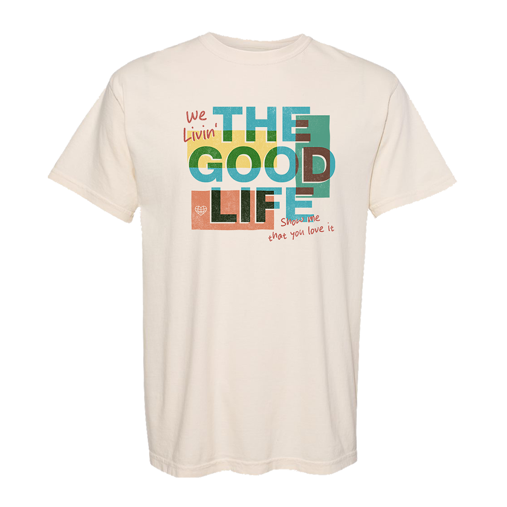 Off-white t-shirt with colorful text saying ’We Livin’ THE GOOD LIFE show me that you love it’.