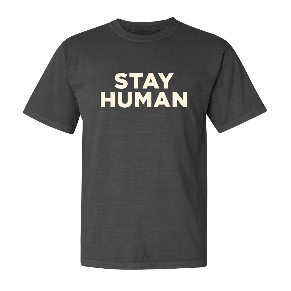 Dark gray t-shirt with ’STAY HUMAN’ printed in large white letters on the front.