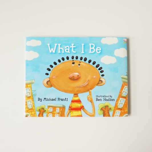 Children’s book cover titled ’What I Be’ featuring a cartoon character with a round orange face and spiky hair.