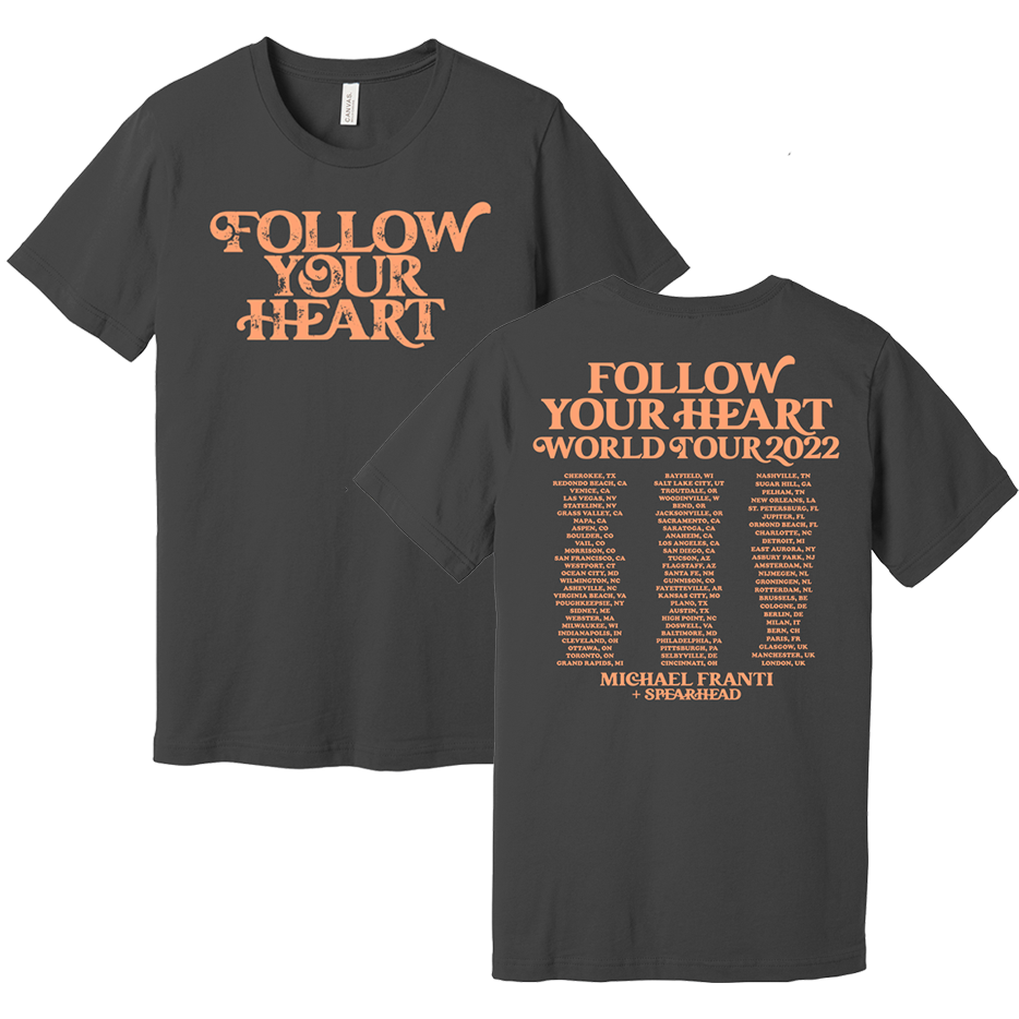 Dark gray t-shirt with ’Follow Your Heart’ text and tour dates printed on it.